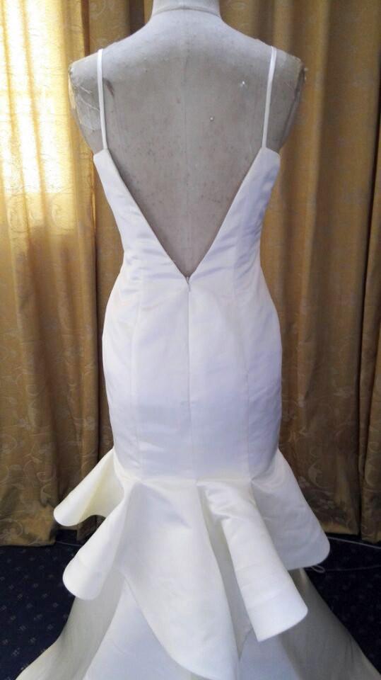 peplum mermaid wedding dress FAINA dress available for fitting in @demure_bridal A fishtail wedding dress with a removable peplum. The corset is complemented with fine lace and has a low waistline. The bottom of the corset